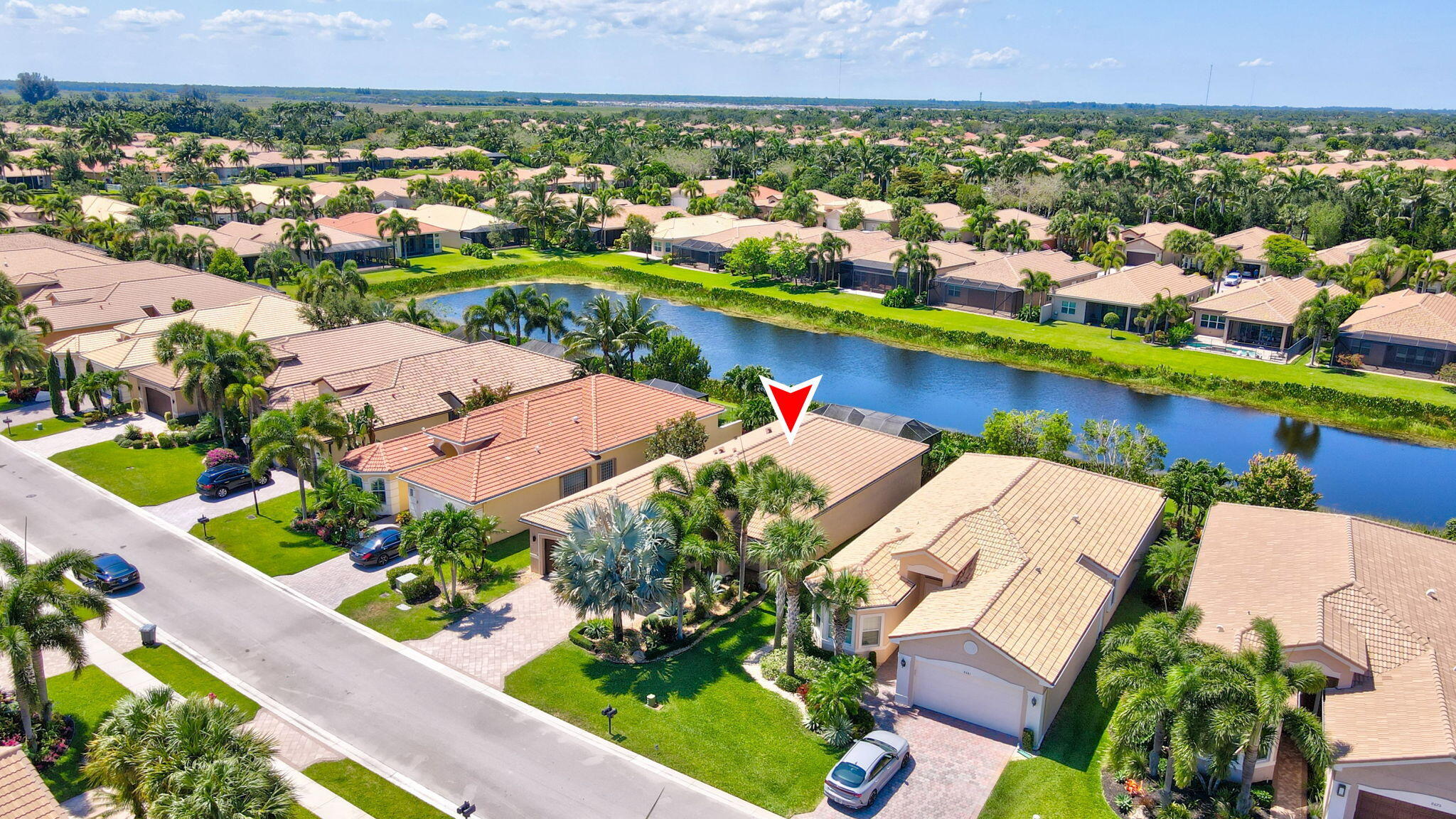 an aerial view of a house with a garden and lake view