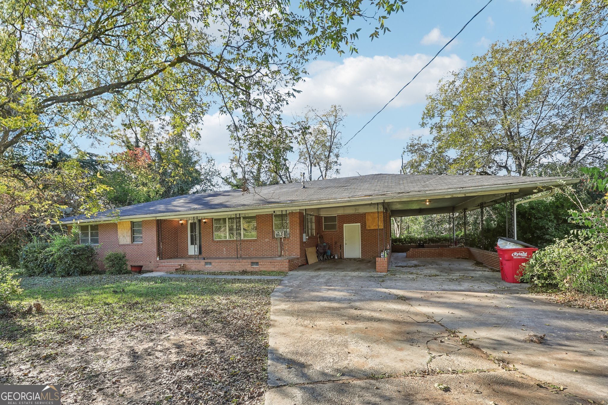 a front view of house with yard and trees around