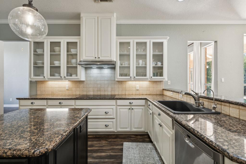 a kitchen with granite countertop a sink and cabinets