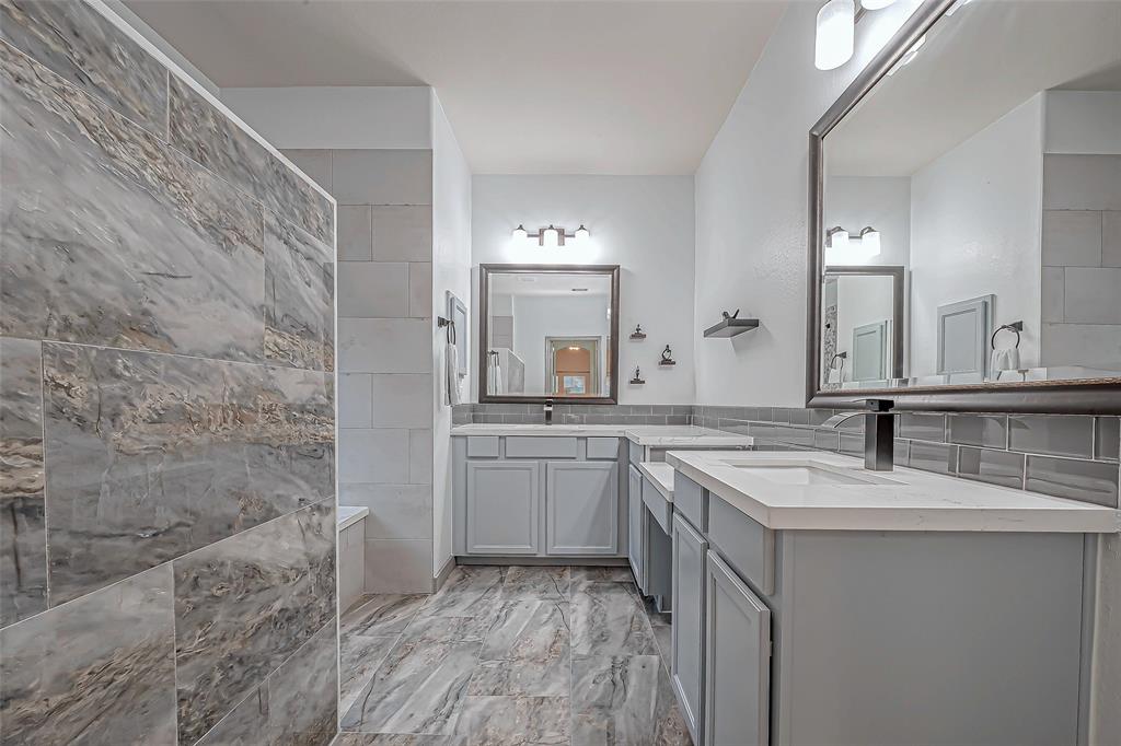 Luxurious primary ensuite bath with double sink areas and vanity