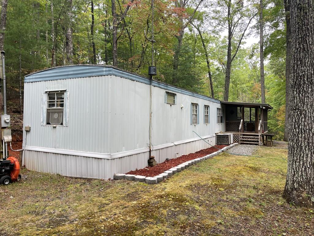 a view of a house with backyard and trees