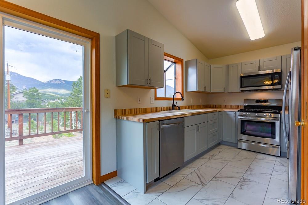 a kitchen with a refrigerator and a stove