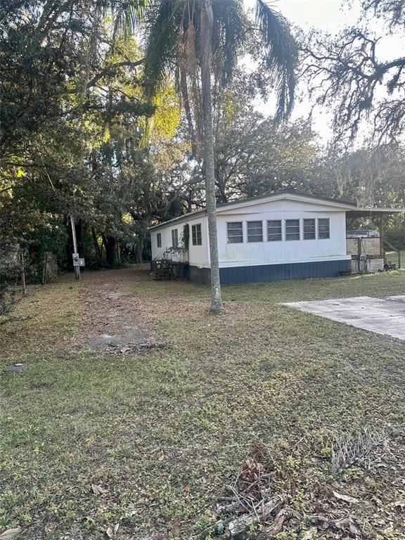 a view of a house with a yard and sitting area