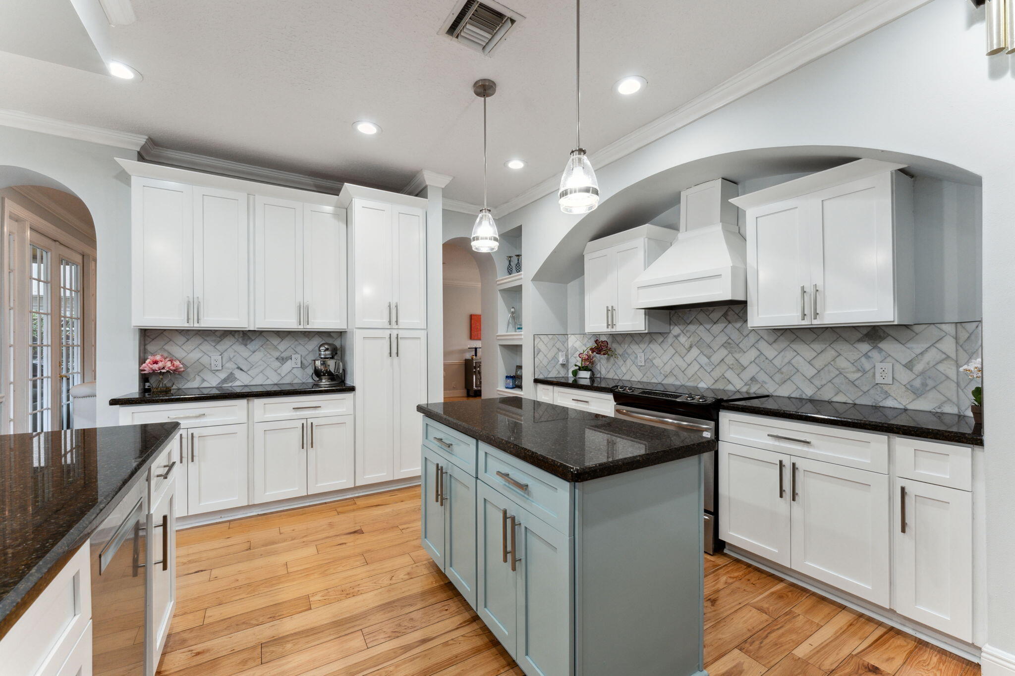 a kitchen with stainless steel appliances granite countertop a sink stove and cabinets