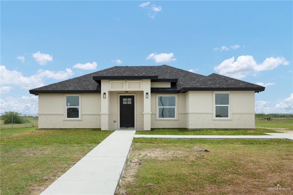 a front view of a house with yard