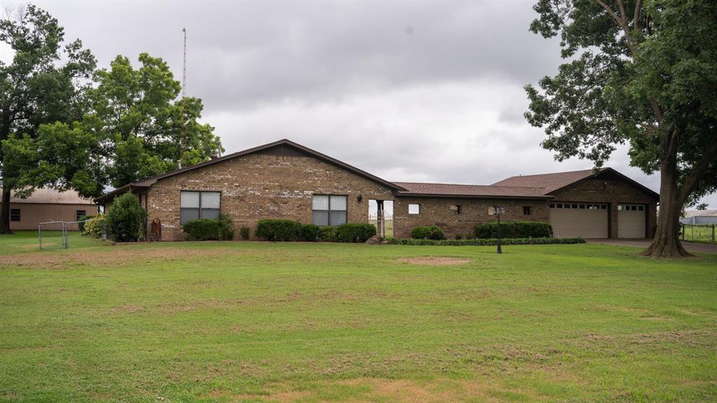 a front view of house with yard and green space