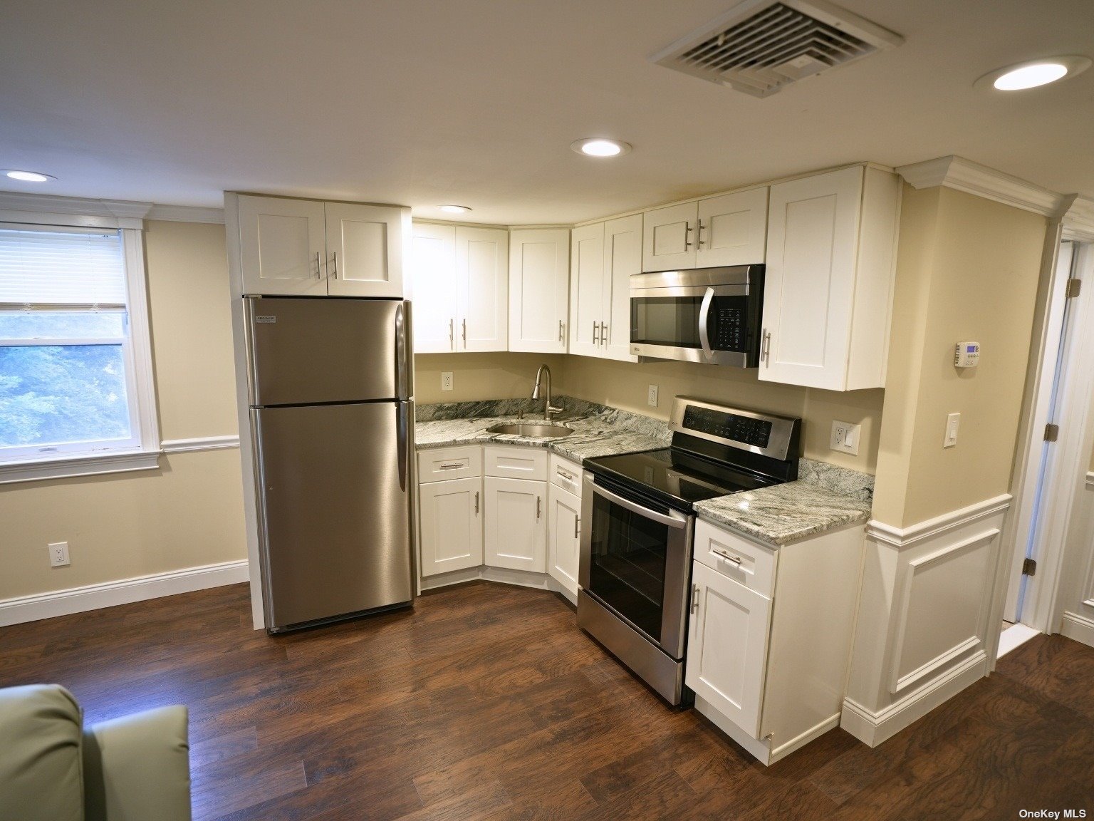 a kitchen with a refrigerator stove and sink