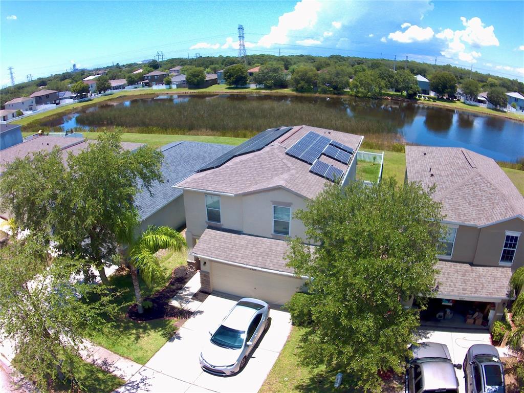 an aerial view of a house with a lake view