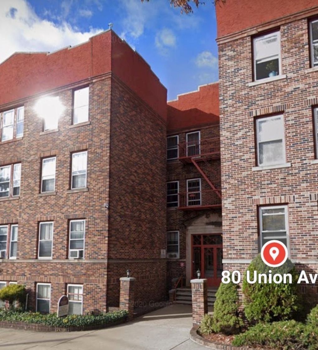 a view of a brick building with many windows