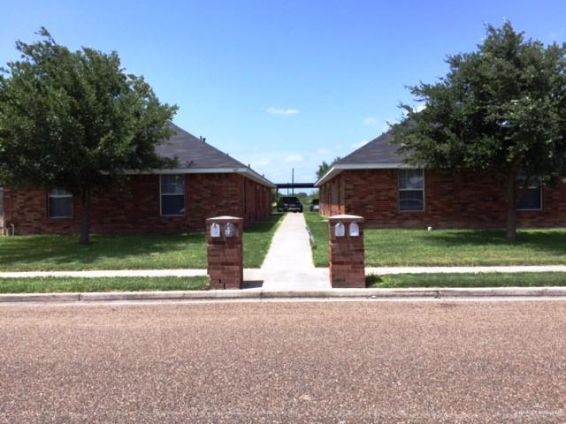 a view of a house with a yard and a garage