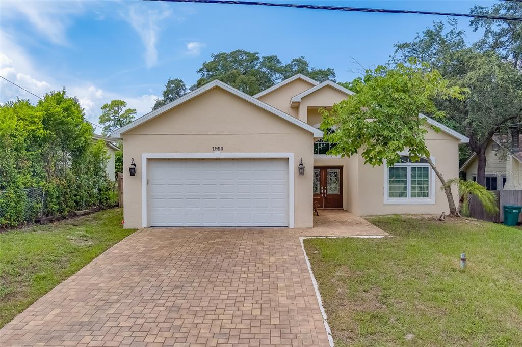 front view of a house with a yard and an trees