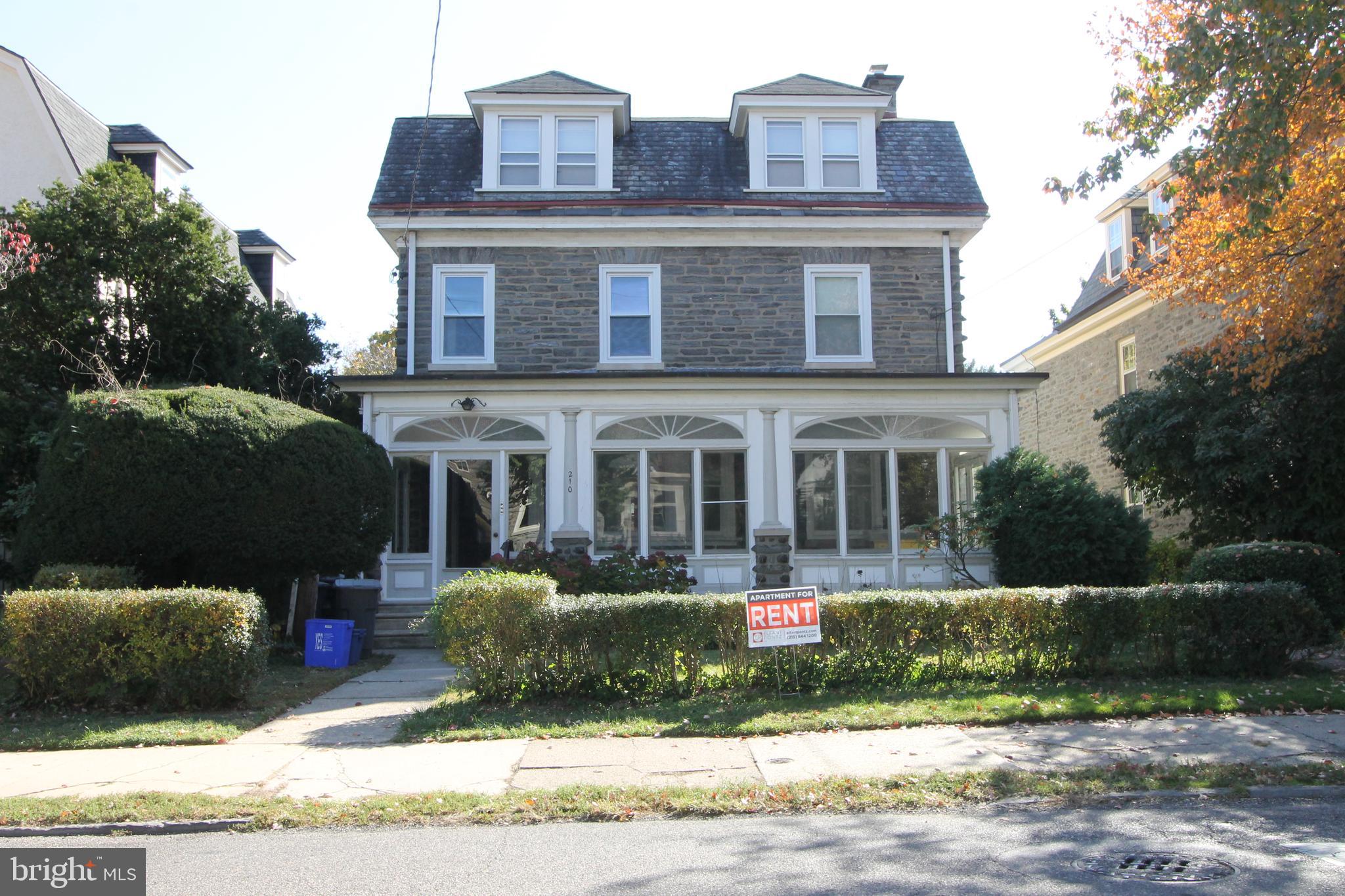 a view of a house with a patio and a yard