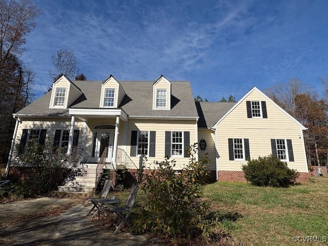 Cape cod-style house with a front lawn