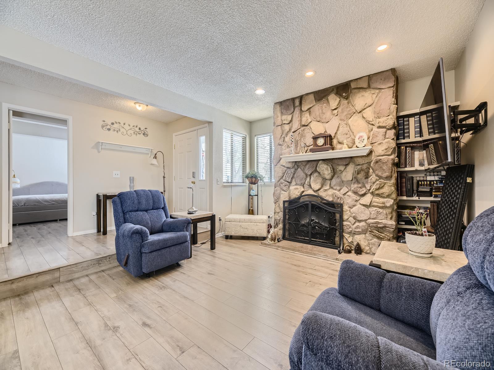 a living room with furniture and a fireplace