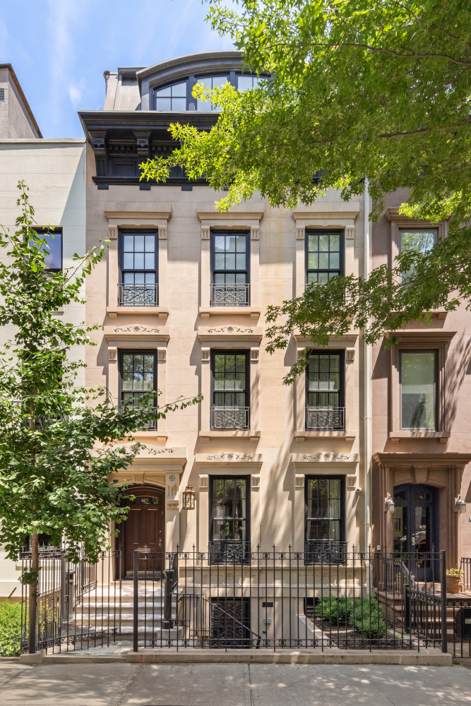 a front view of a residential apartment building with a yard