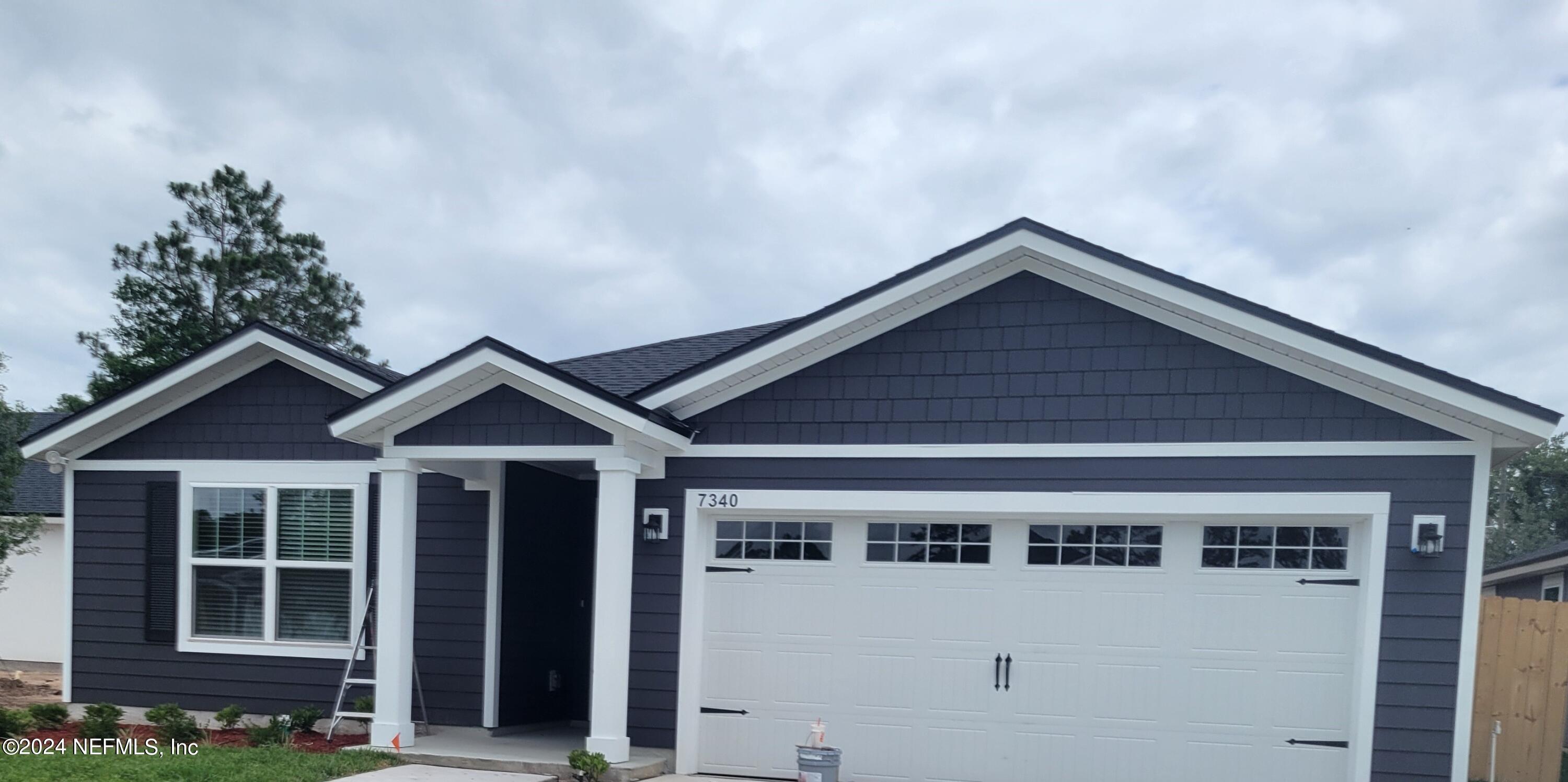 a front view of a house with garage