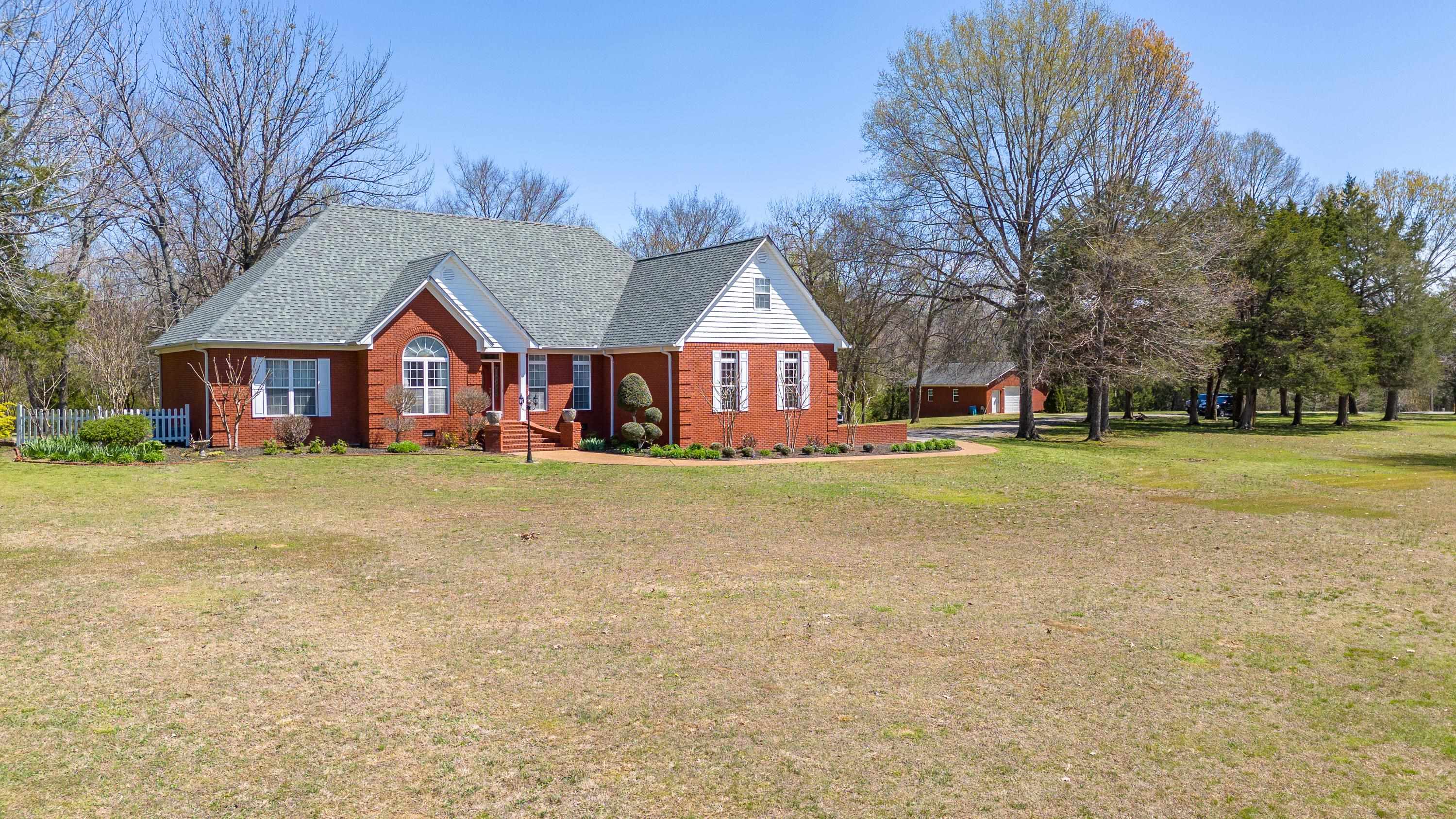 a front view of house with yard and green space