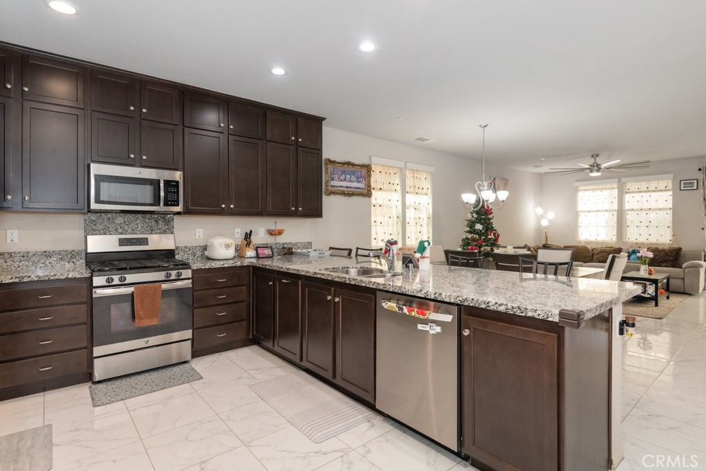 a kitchen with stainless steel appliances granite countertop a sink and stove