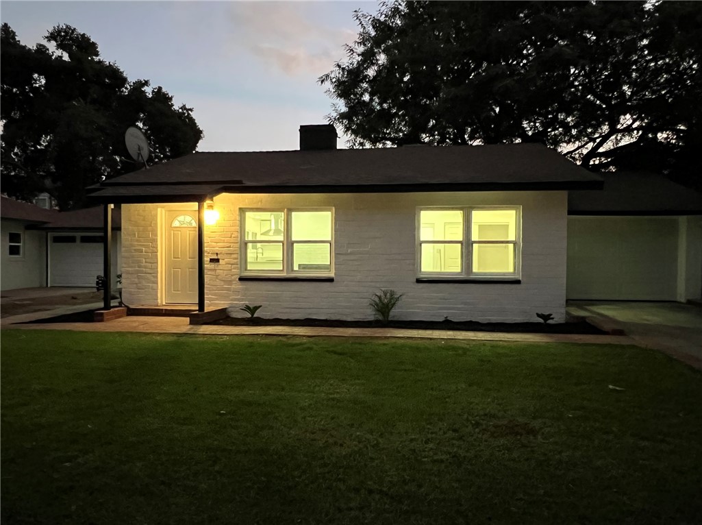 a view of a house with a yard