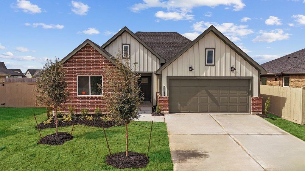 a front view of house with backyard and green space