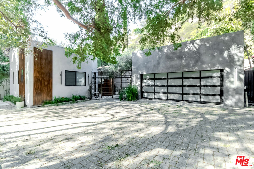 a view of a house with a yard and garage