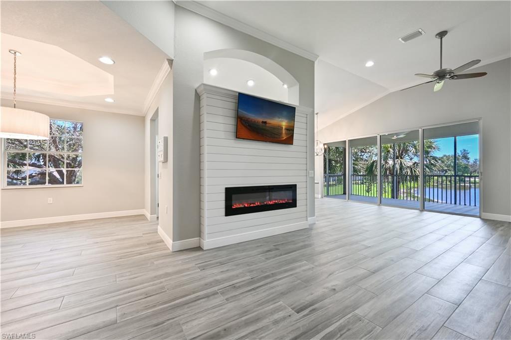 Unfurnished living room with plenty of natural light, light hardwood / wood-style floors, and ceiling fan