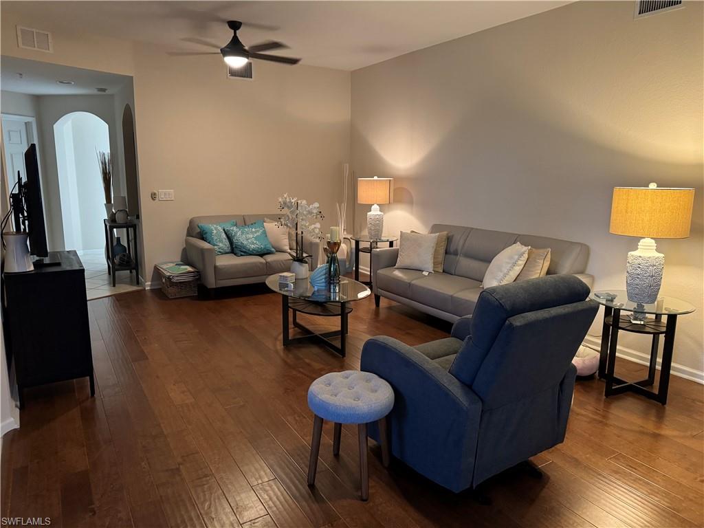 a living room with furniture and a wooden floor