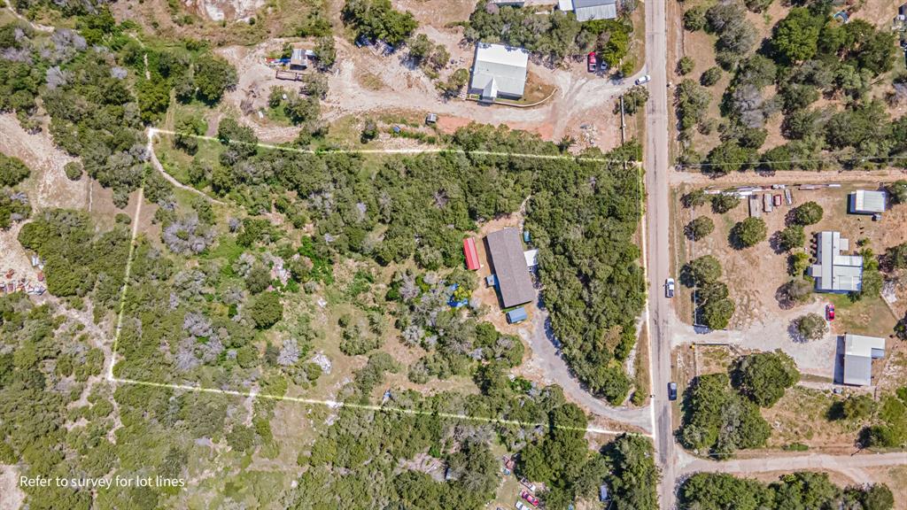 an aerial view of residential houses with yard