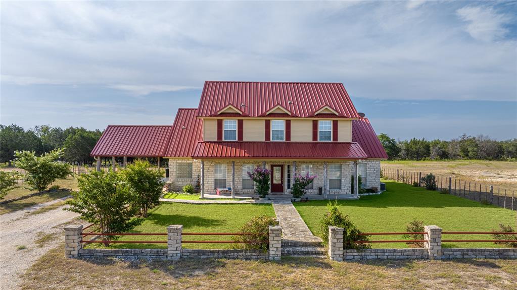 a view of a house with swimming pool and a yard