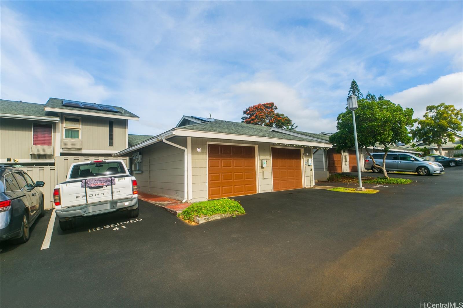 a view of a house with a cars park