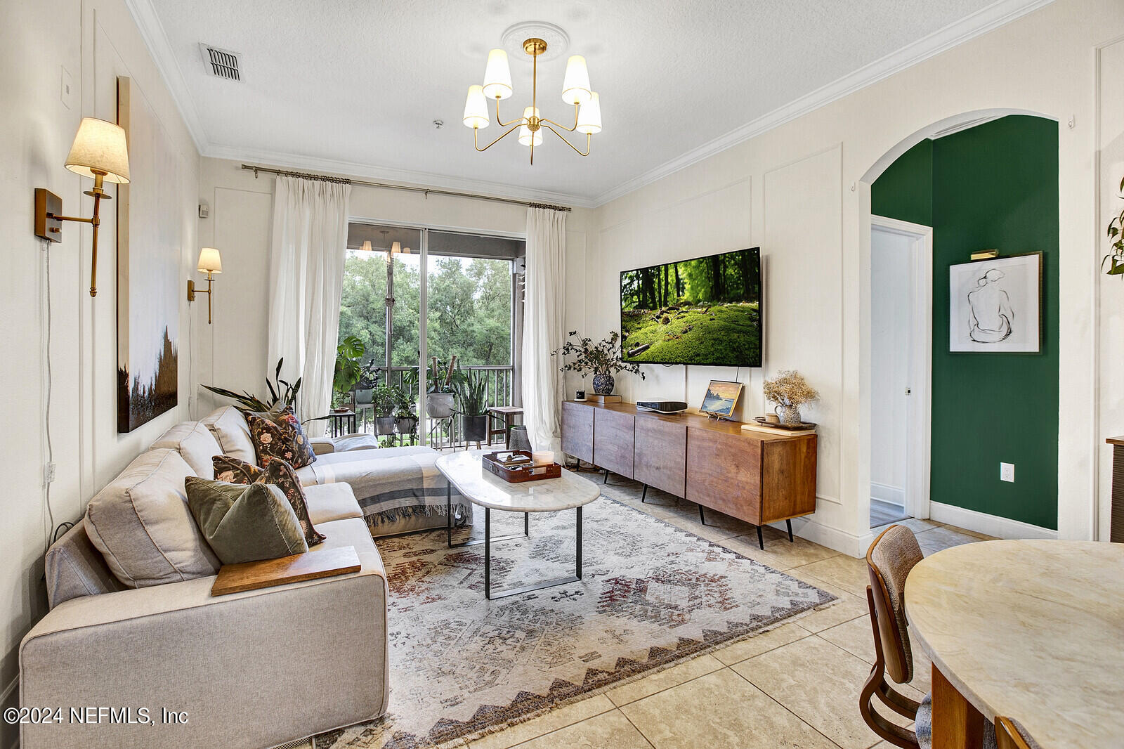 a living room with furniture and a flat screen tv