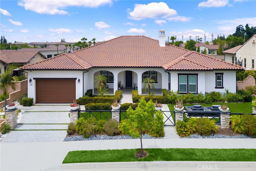 a front view of a house with a garden