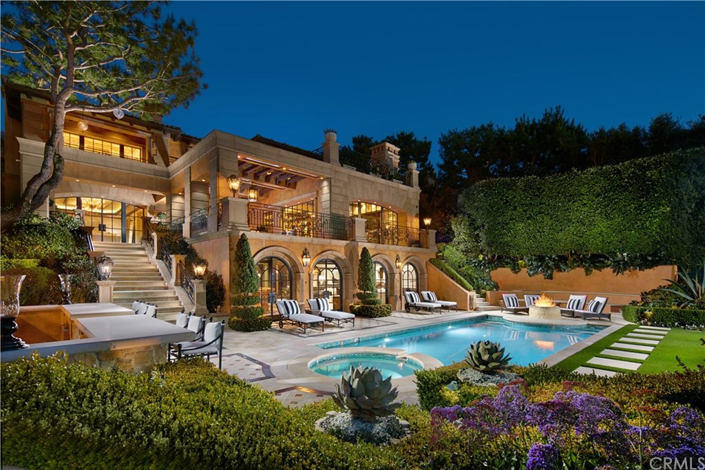 an aerial view of a house with a garden and lake view