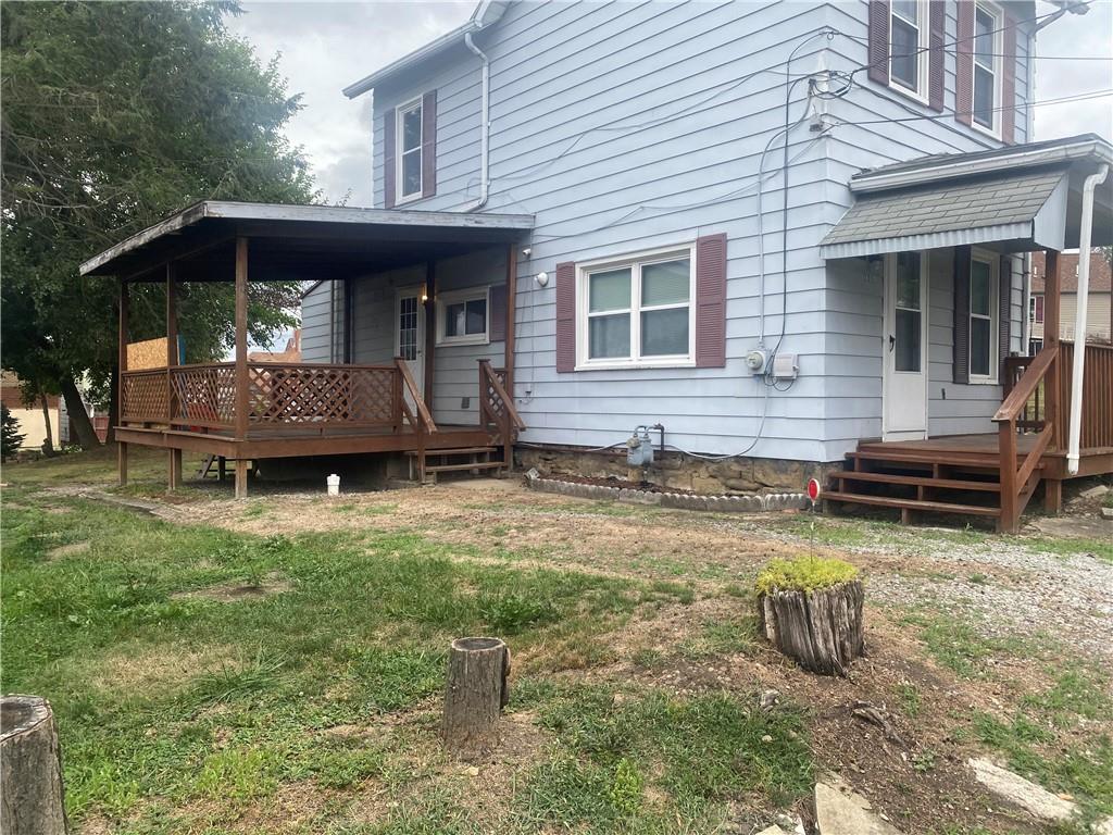 a view of house with backyard