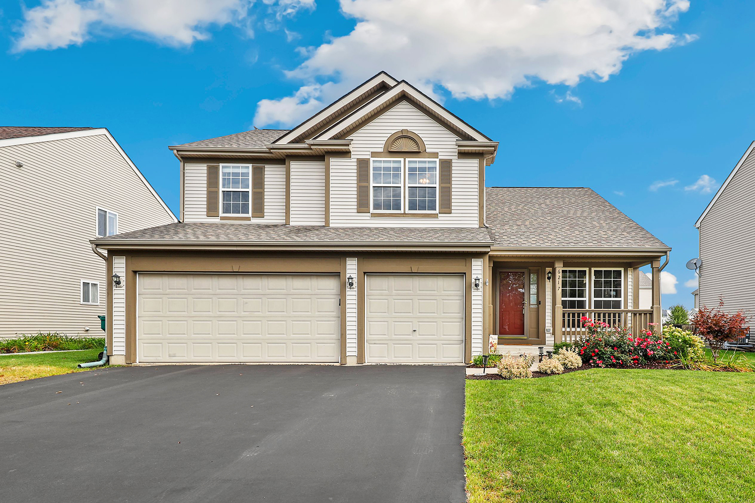 a front view of a house with a yard and garage