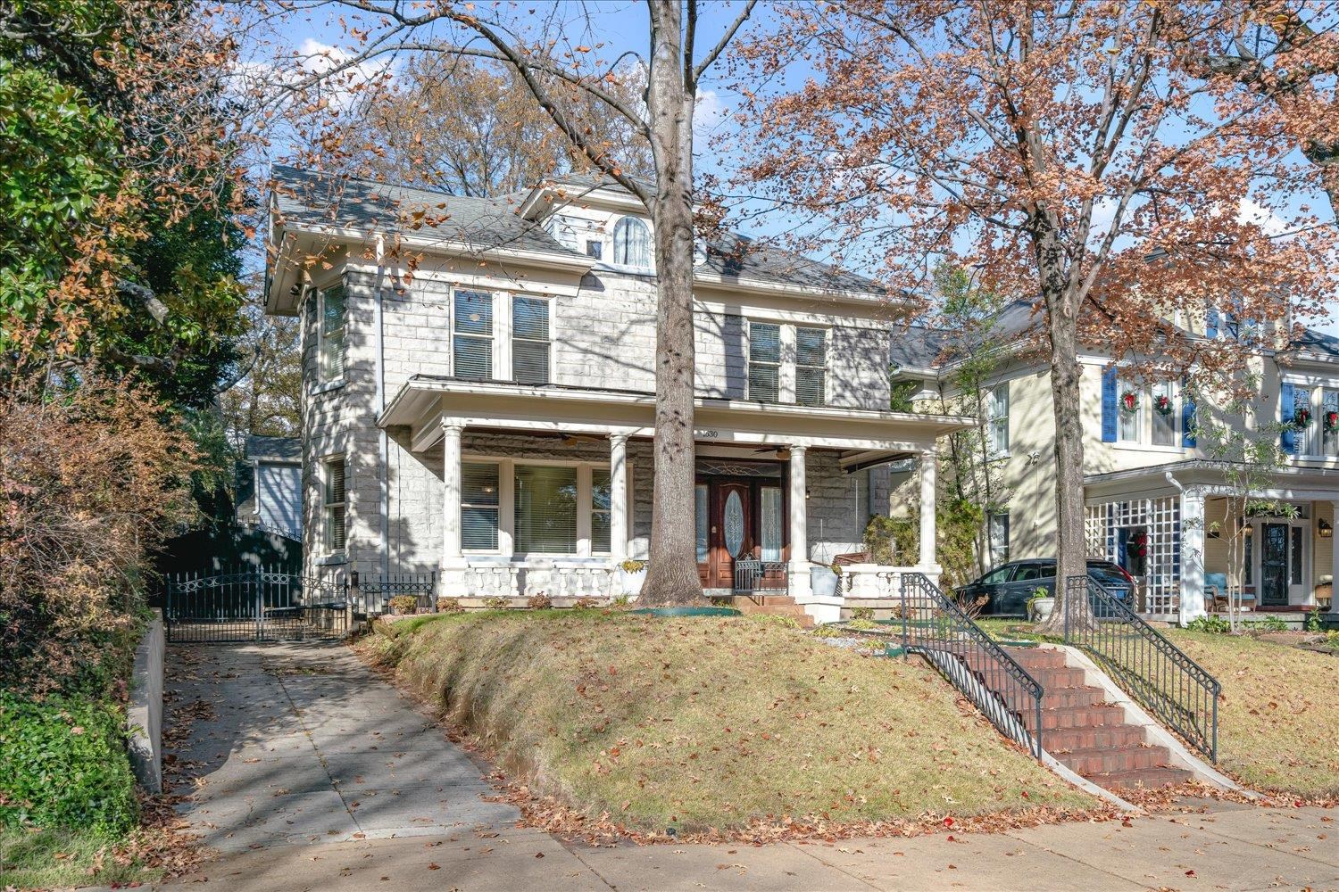 View of front property featuring a front lawn and a porch