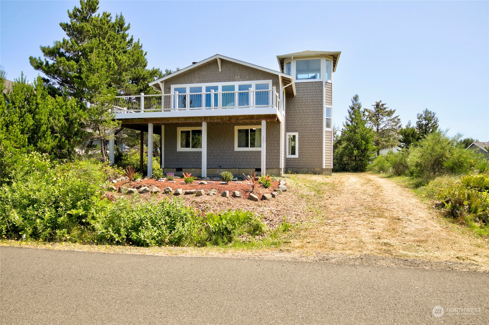 a front view of a house with a garden