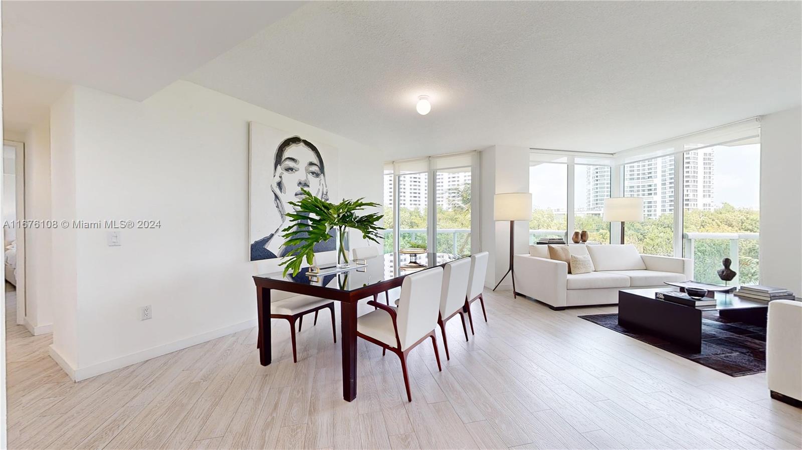 a living room with furniture a window and wooden floor