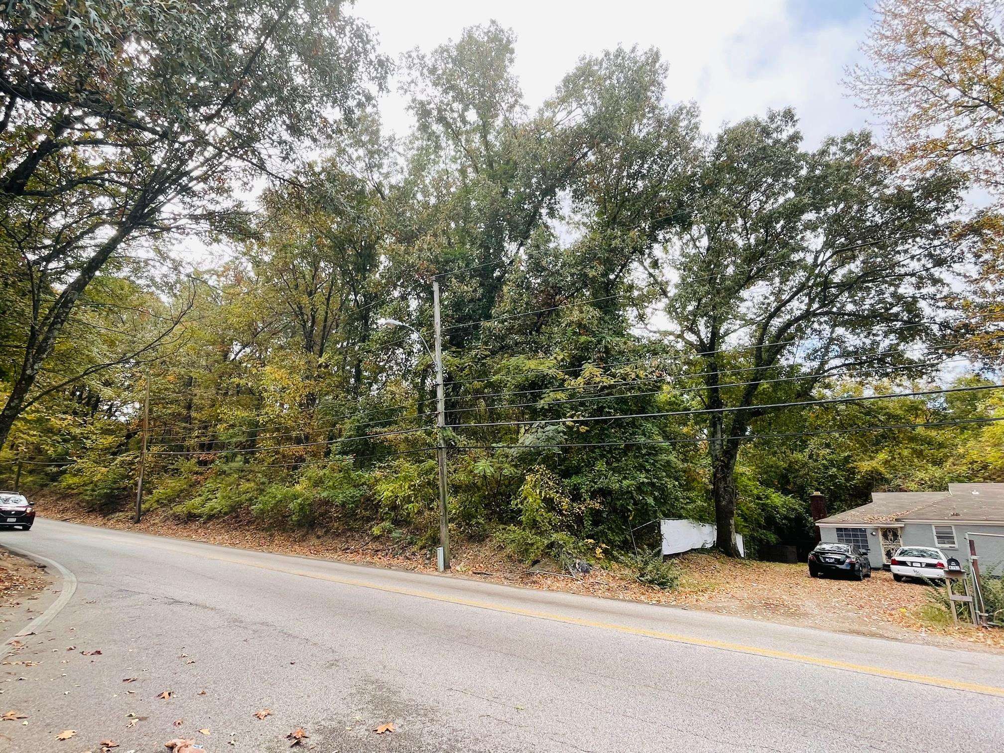 an outdoor view of a house with a yard and tree s