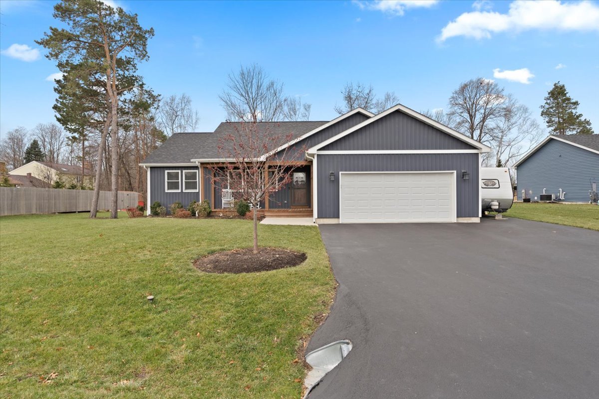 a front view of a house with a yard and garage