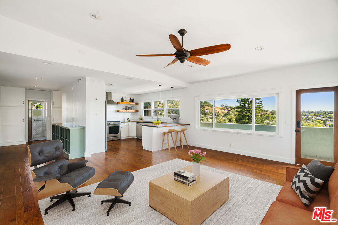 a living room with furniture and a wooden floor