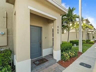 a couple of palm trees in front of door