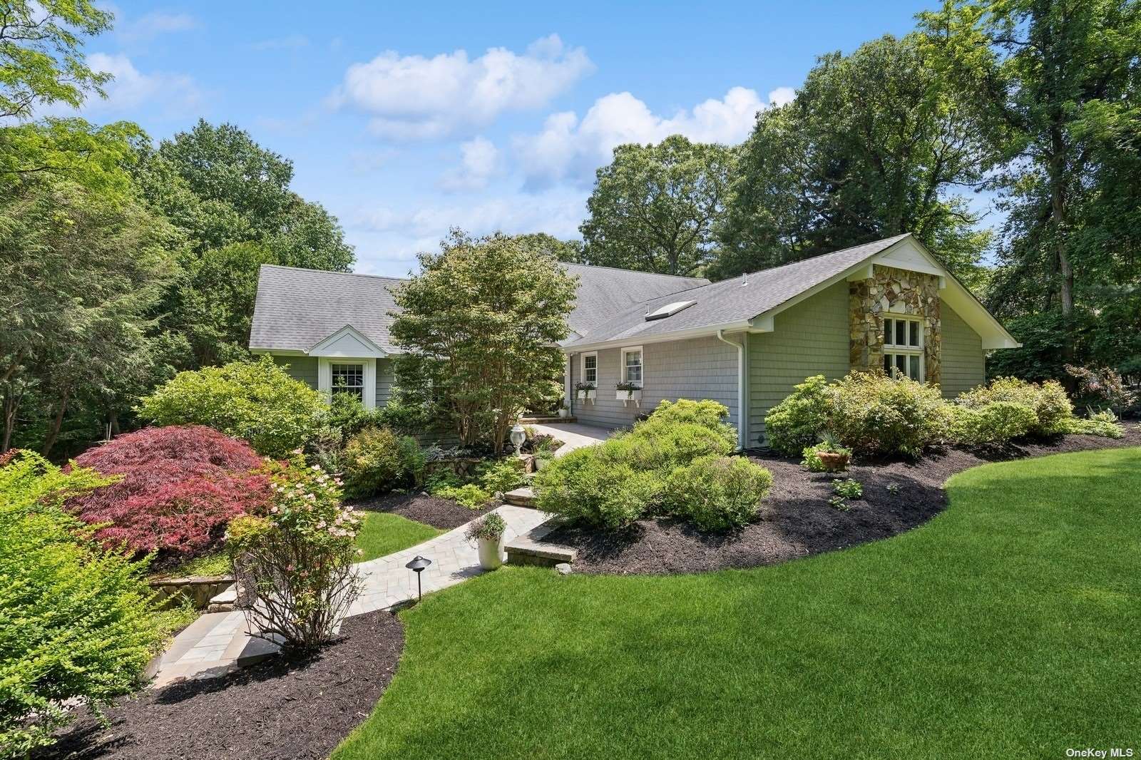 a view of a house with a yard and garden