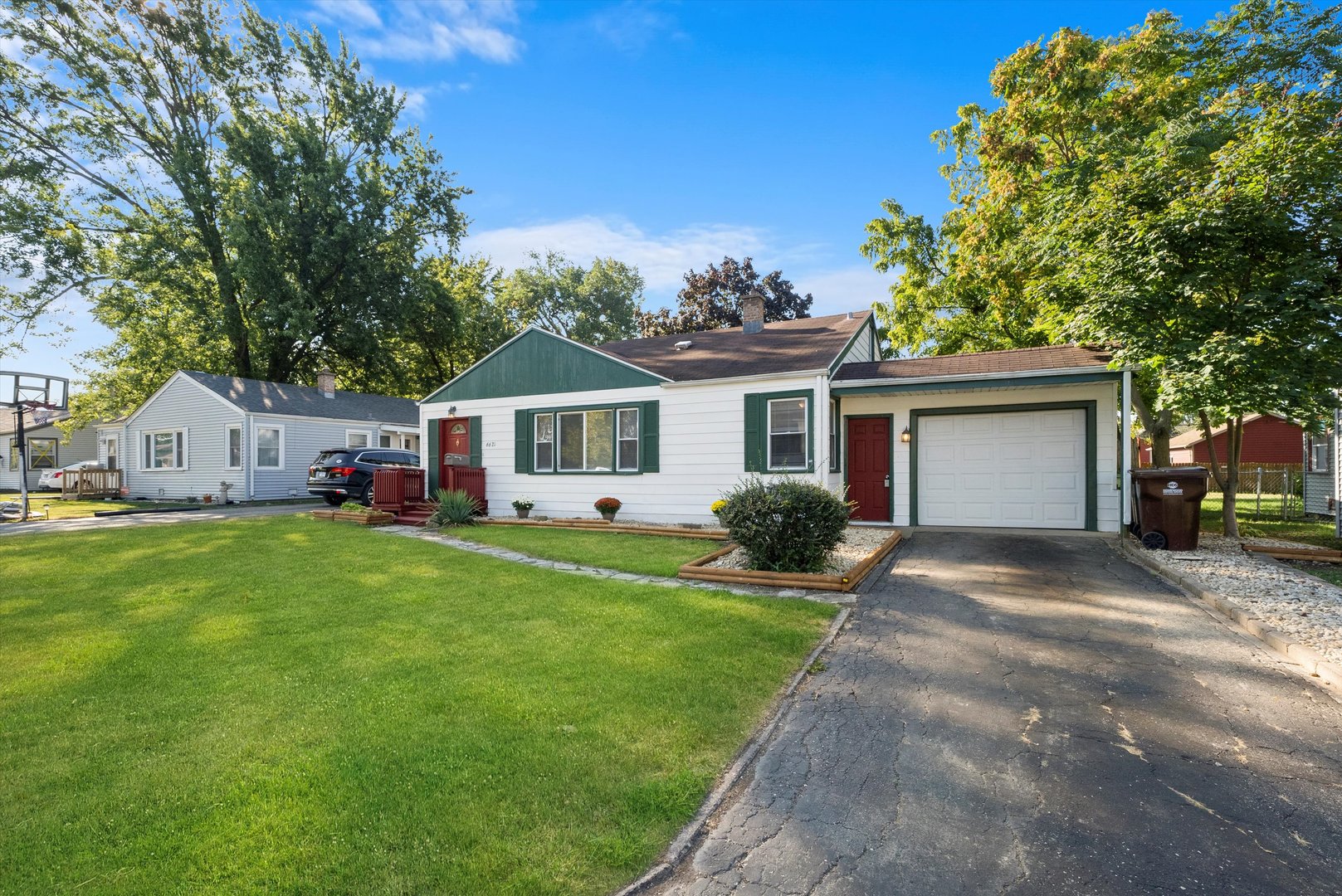 a front view of house with yard and green space