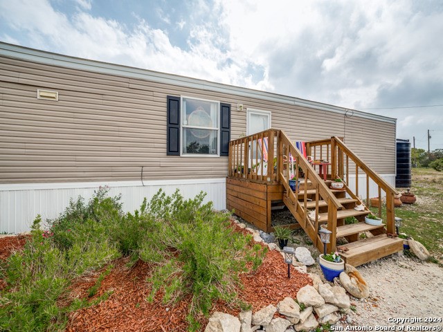 a view of a house with backyard and deck