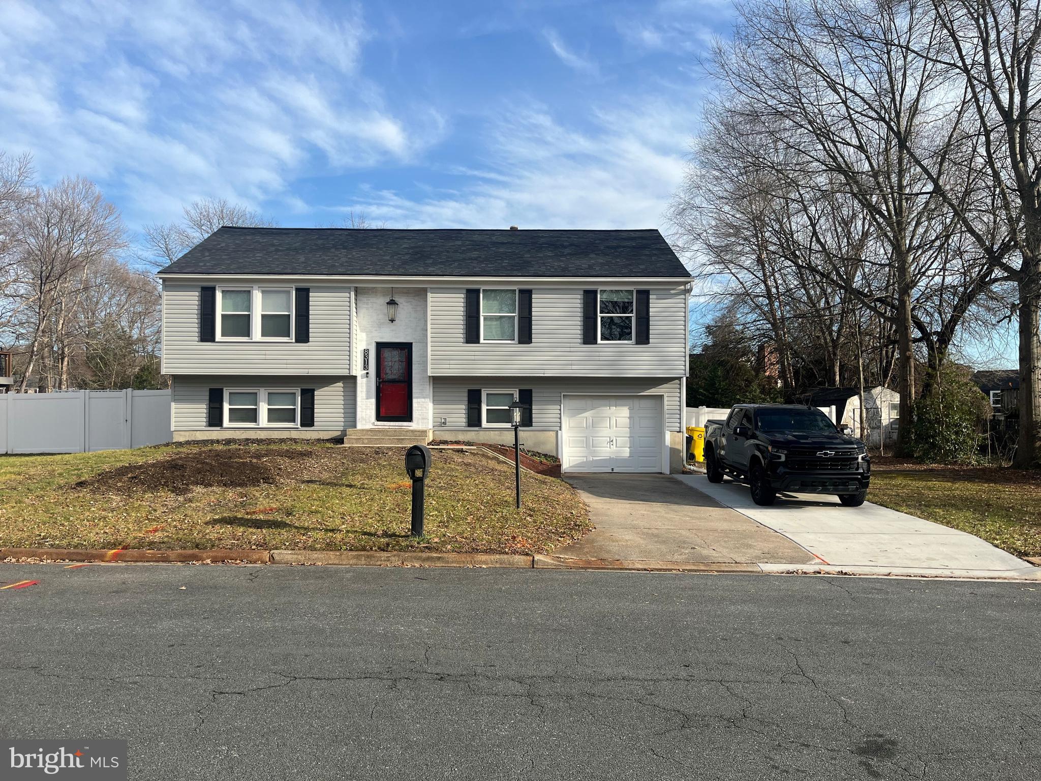 a front view of a house with cars parked