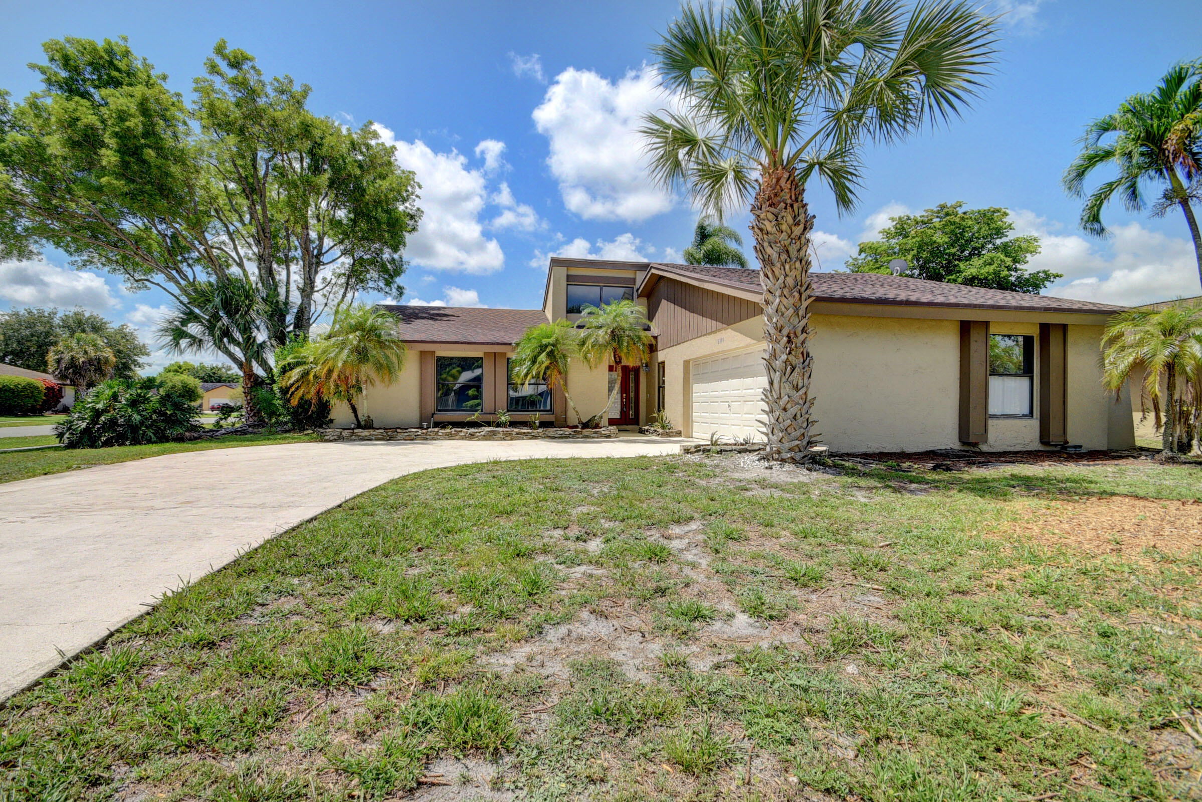 a front view of house with yard and green space