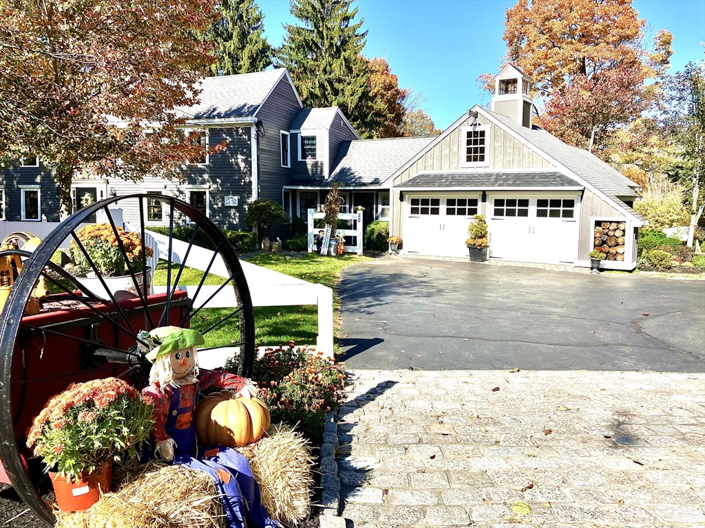 a front view of a house with a yard and a garden