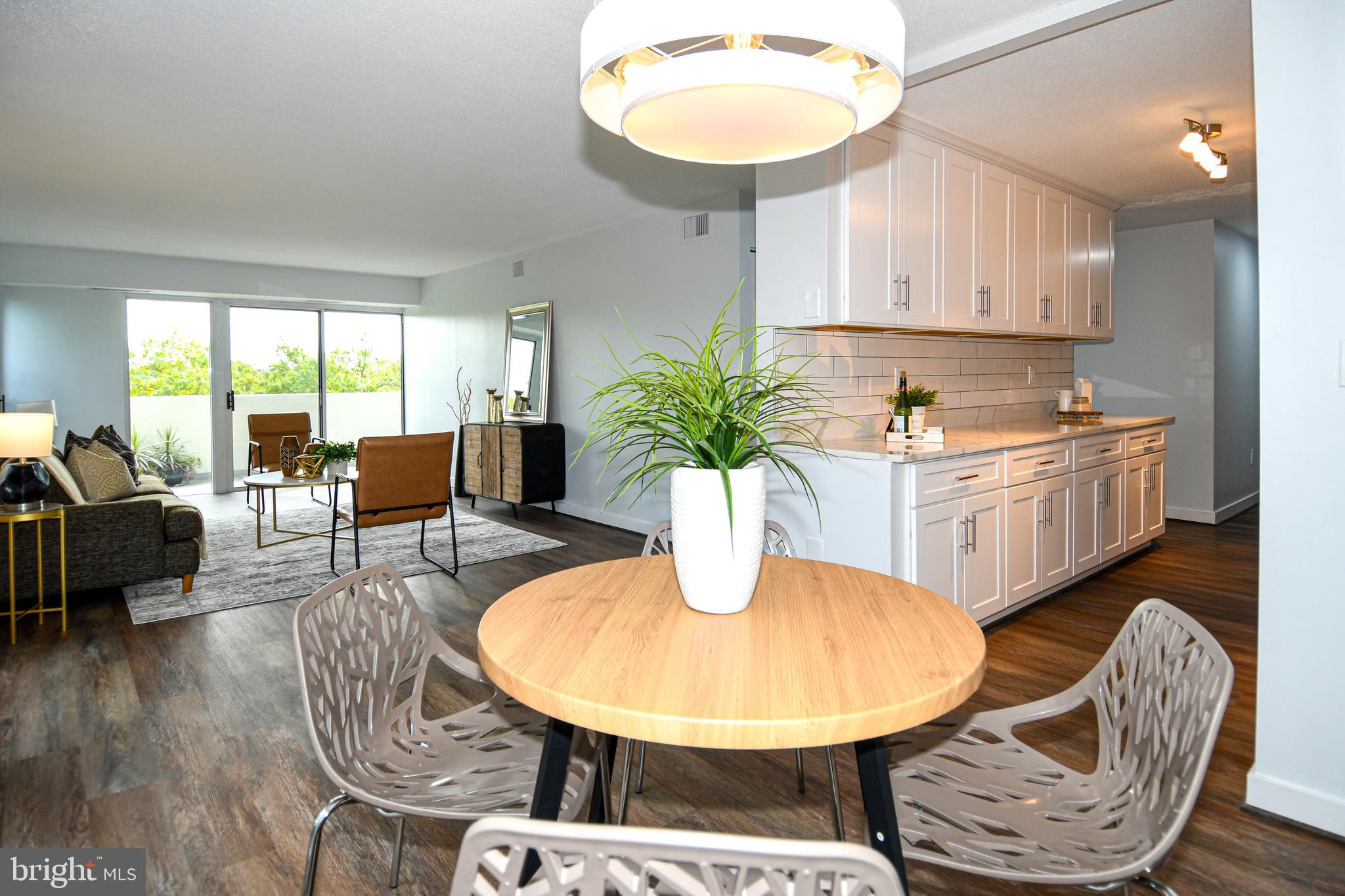 a dining room with furniture and wooden floor