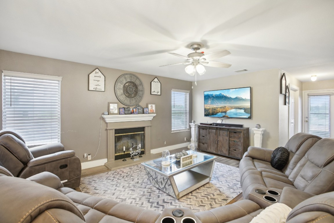 a living room with furniture a fireplace and a flat screen tv